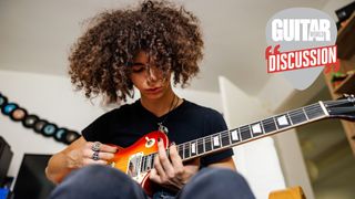 A seated teenager plays a Les Paul