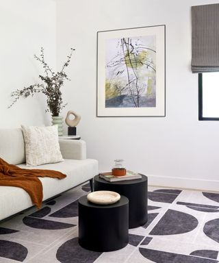 neutral modern office with a monochrome geometric rug and a small seating area