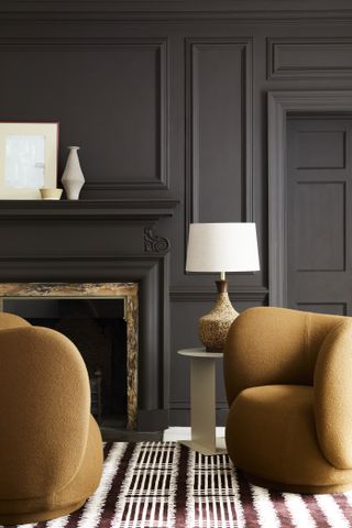 dark grey living room with mustard furniture by Little Greene