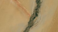 A satellite photo of a massive Y-shape int he desert made of a river and mountain ridge