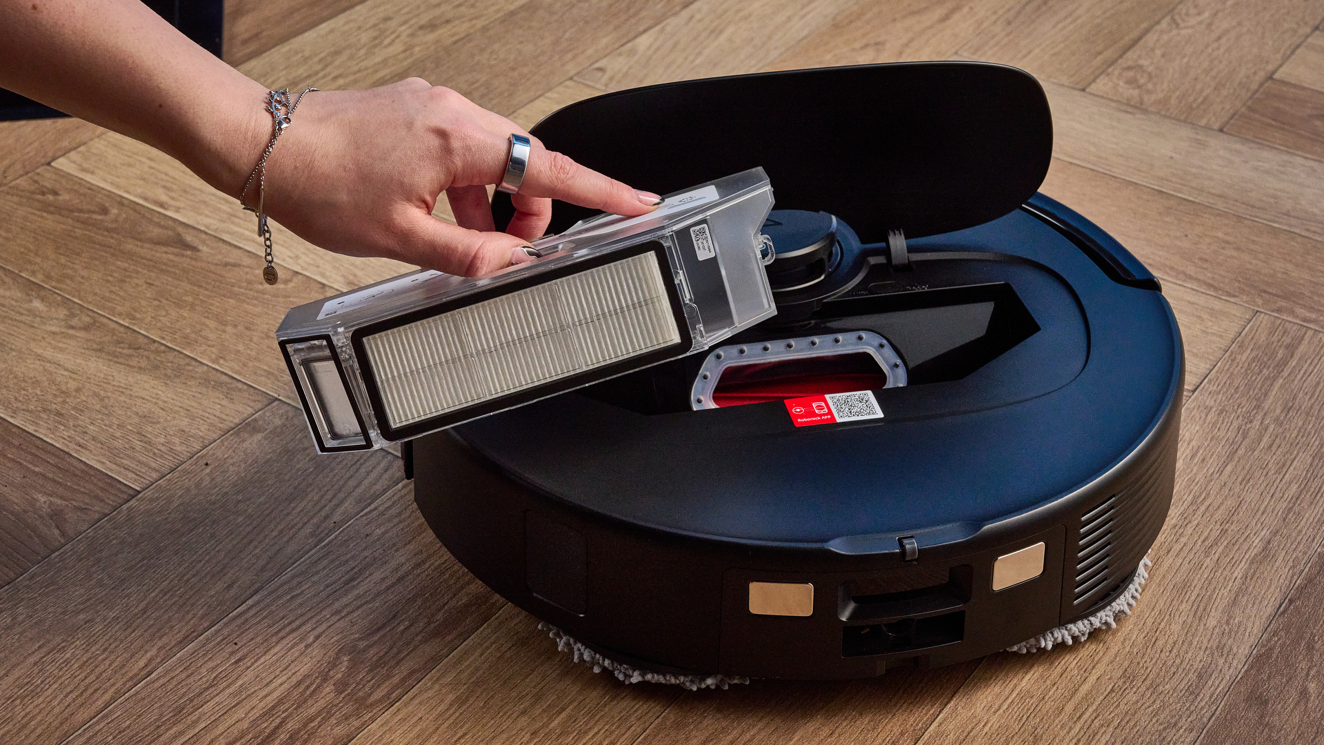 Dustbin of the Roborock QV 35S photographed in front of a blue background