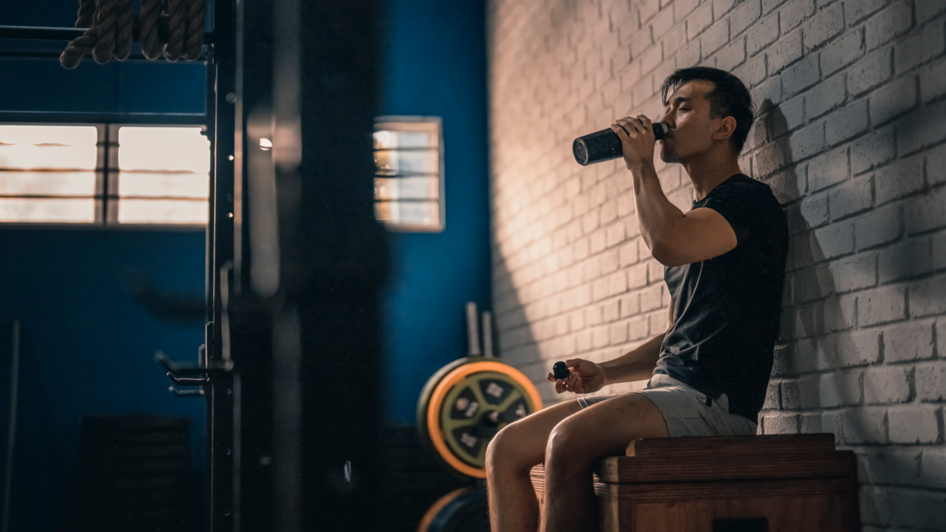 A man drinking pre workout at the gym