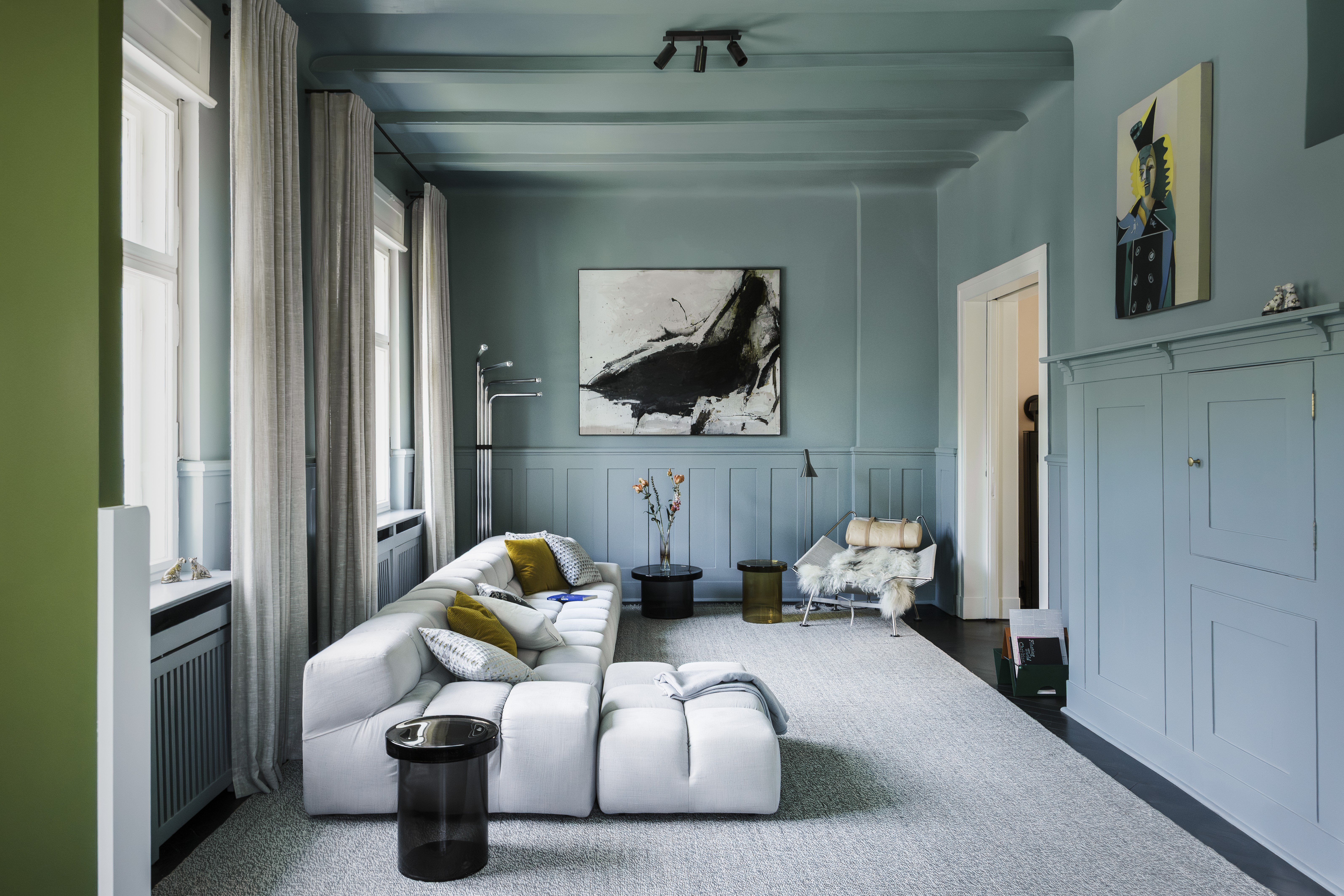 Balancedly designed interiors with plenty of natural light, pastel palettes, sculptural pieces, and curated artwork, with floor-to-ceiling walls and arched walls.