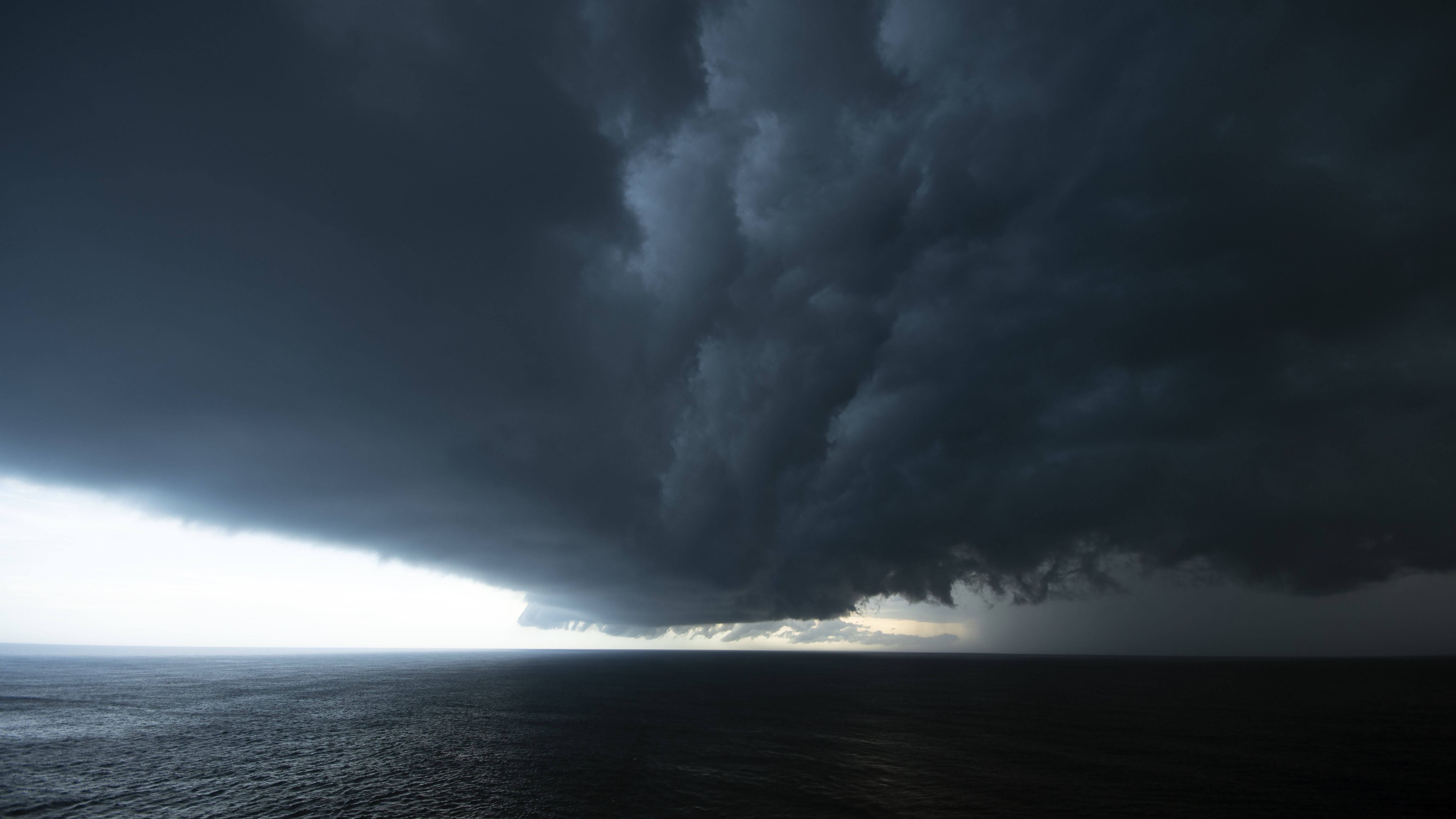 Storm clouds hang over the sea.