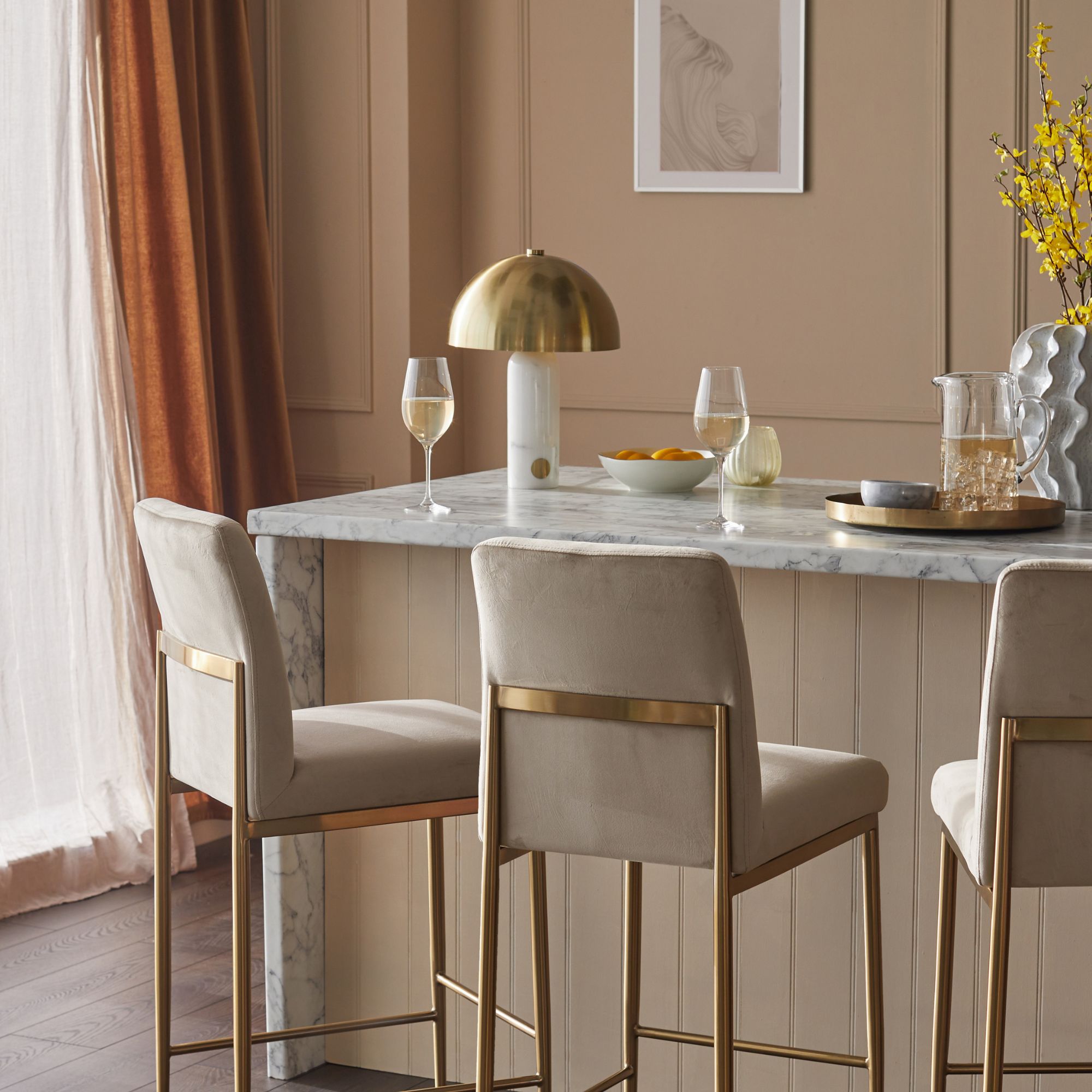 Gold bar area with marble island and brushed brass lamp