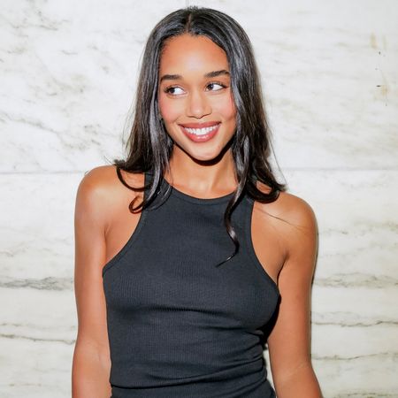 laura harrier at a new york fashion week dinner with jcrew wearing a black tank top and trousers