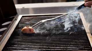 how to clean a BBQ grill with an onion on the end of a BBQ fork