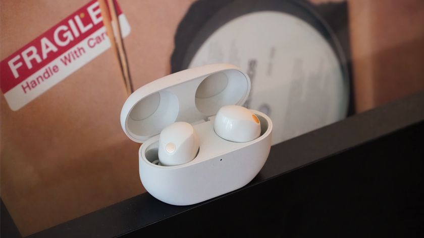 The Sony WF-1000XM5 earbuds on a record stand.