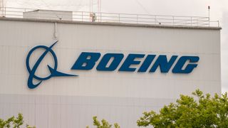 The Boeing logo in blue on the side of a building, shot with a telephoto lens.