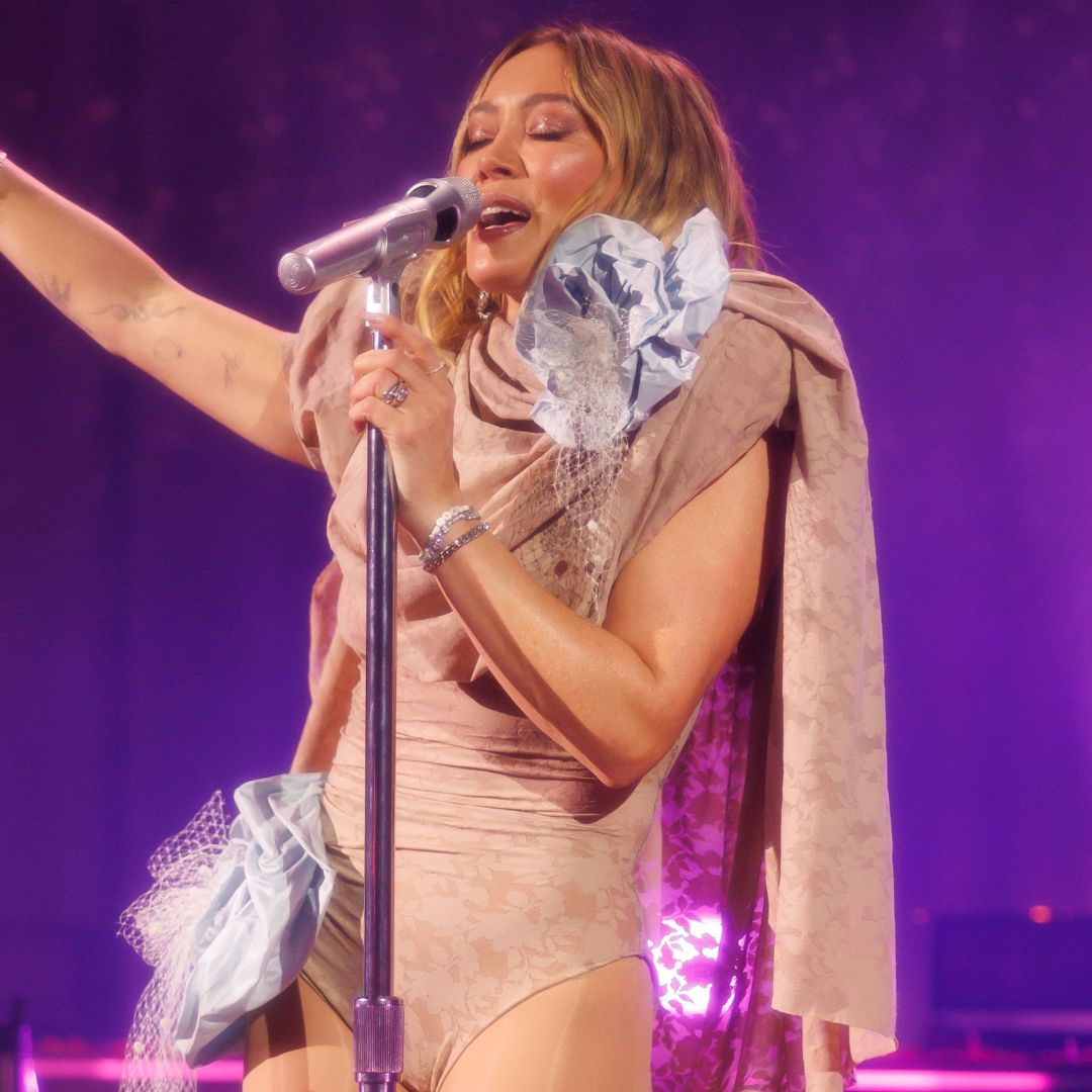 Hilary Duff opened her comeback concert tour in a Y2K nude bodysuit and knee-high go go boots