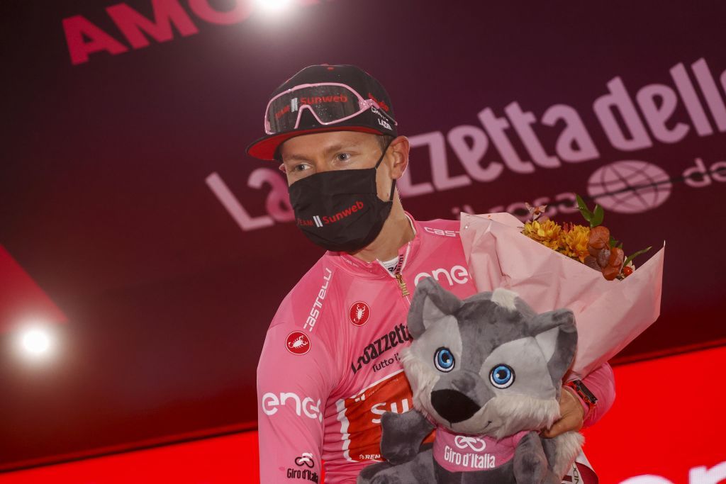 Team Sunweb rider Netherlands Wilco Kelderman wearing the overall leaders pink jersey celebrates on the podium after the 19th stage of the Giro dItalia 2020 cycling race a 258kilometer route between Morbegno and Asti on October 23 2020 Heavy rain has interrupted on October 23 2020 the 19th stage of the Giro dItalia following protests by the riders in the face of difficult weather conditions Todays stage was planned to be a flat 258km ride between Morbegno and Asti but was cut back 100km after riders revolted when faced with pelting rain in the northern region of Lombardy Photo by Luca Bettini AFP Photo by LUCA BETTINIAFP via Getty Images