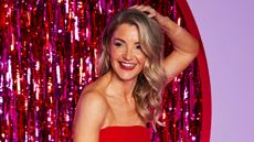 Helen Skelton smiles and leans against a wall during the Red Nose Day night of TV for Comic Relief on March 21, 2025