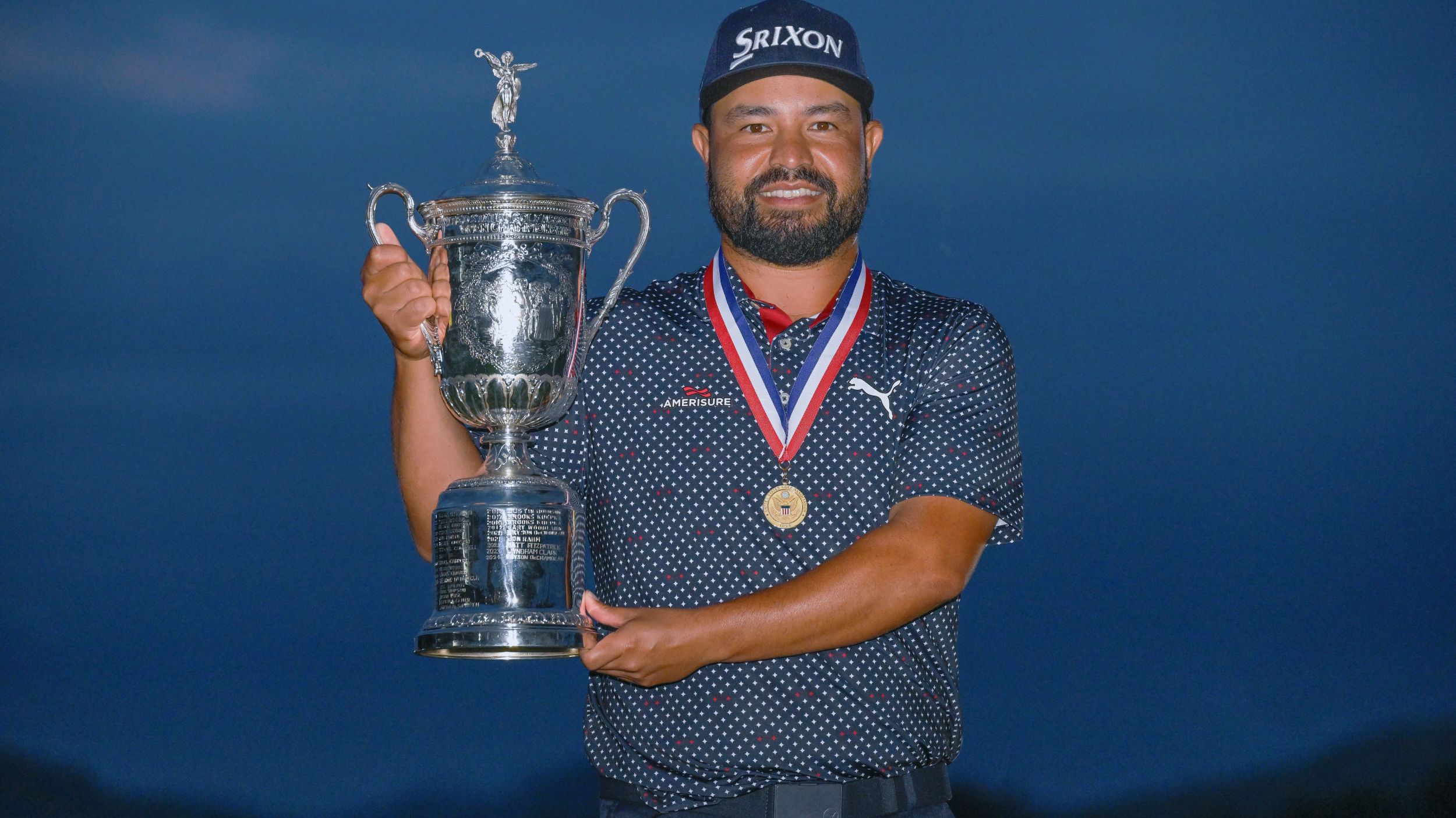 JJ Spaun holds the US Open trophy with the Jack Nicklaus medal around his neck