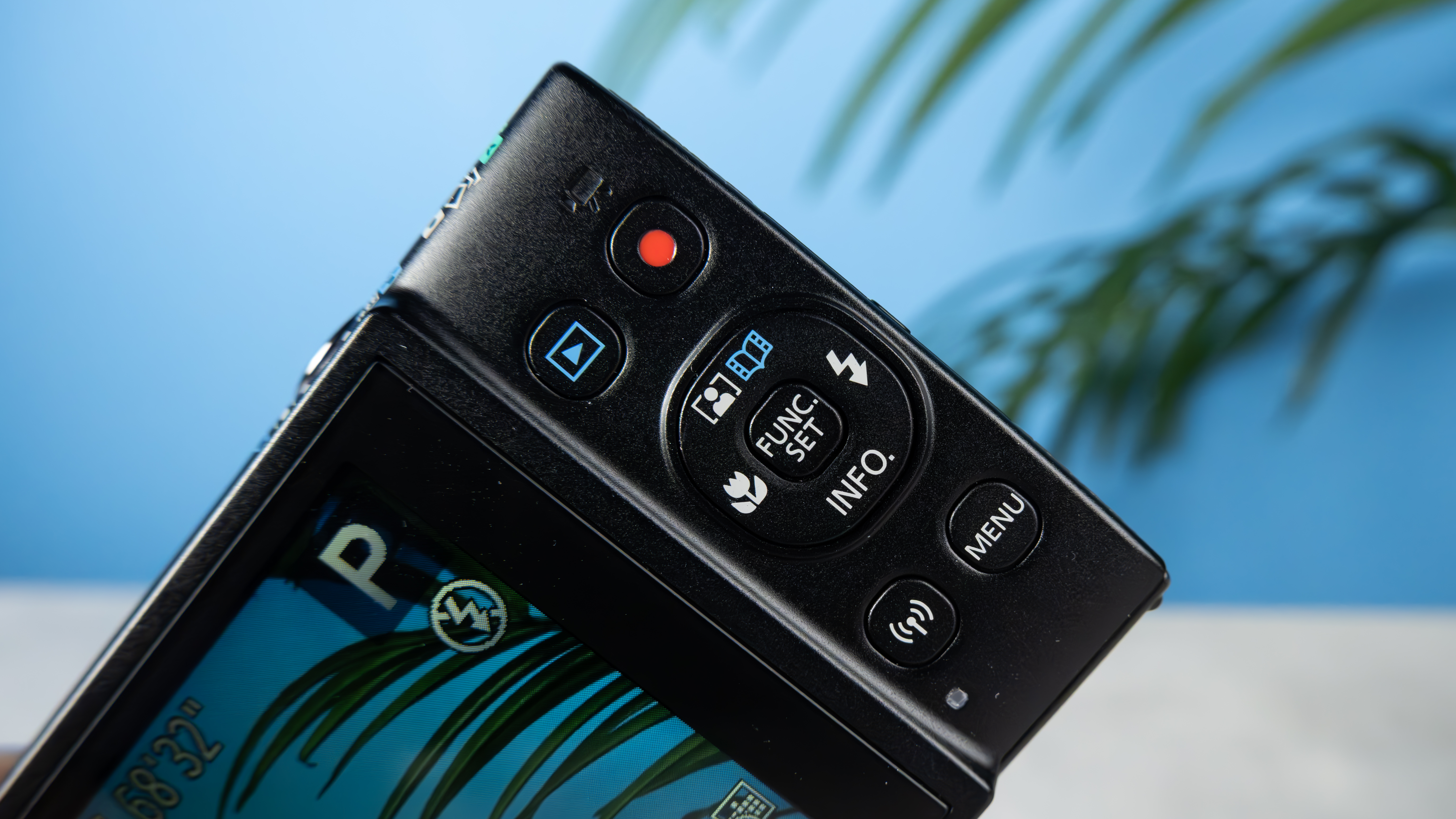 A black Canon PowerShot Elph 360 HS A or Canon PowerShot IXUS 285 HS A compact camera