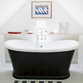Bathroom with bathtub and white wall