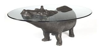 Designer Mark Stoddart uses a glass table top to give the impression that the hippo is emerging from the water