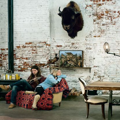 living room with raw wall and wooden table