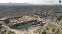 A digitally edited image showing a rendering of a settlement in Saudi Arabia with mountains in the distance