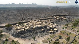 A digitally edited image showing a rendering of a settlement in Saudi Arabia with mountains in the distance