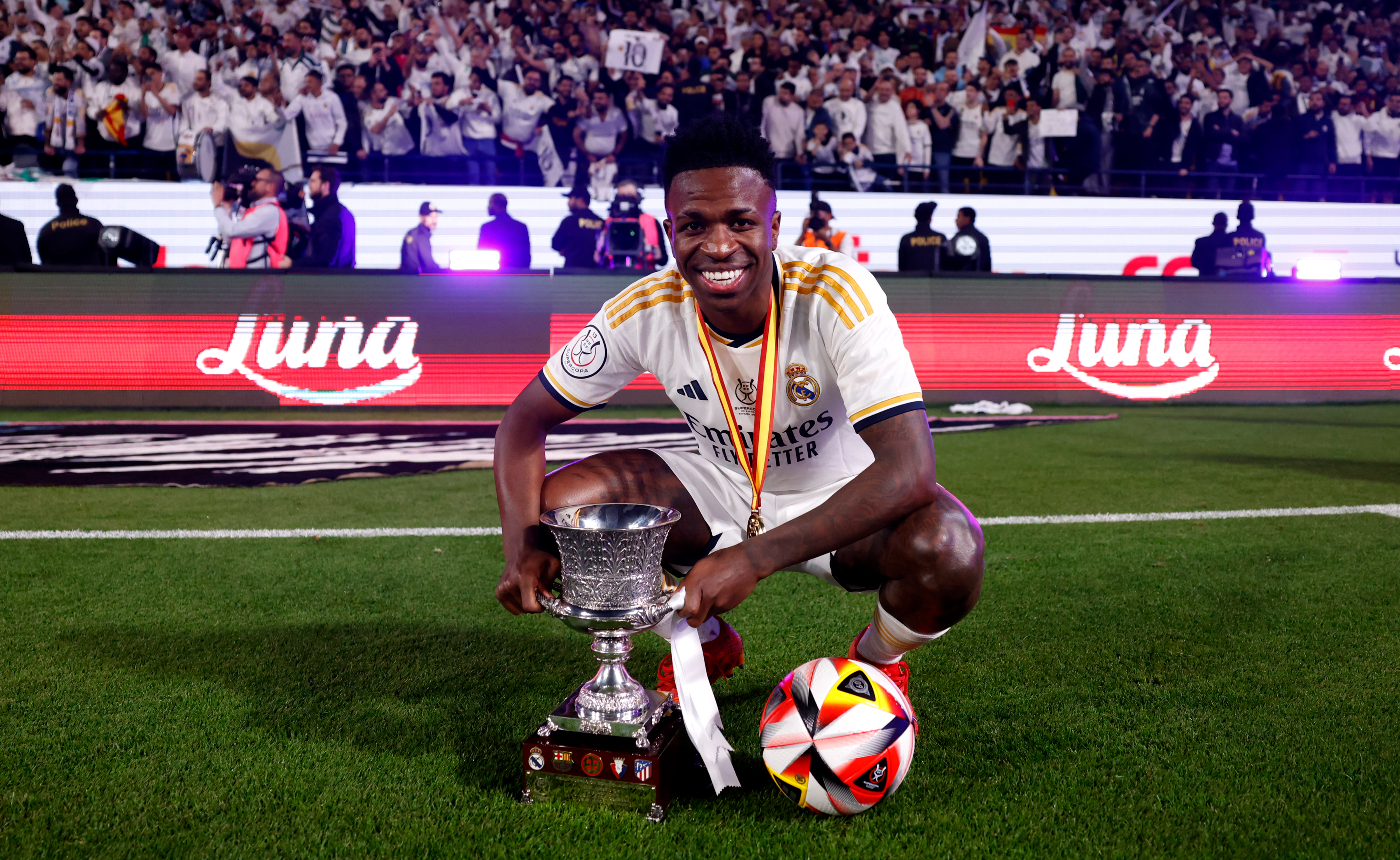 Vinicius Junior celebrates with the match ball and the Supercopa de España trophy after scoring a hat-trick in a 4-1 win for Real Madrid against Barcelona in January 2024.