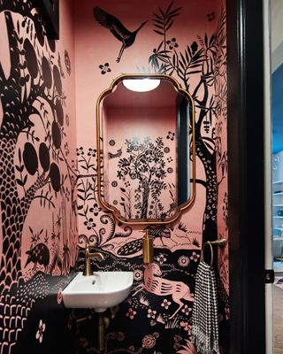 A small bathroom with botanical printed wallpaper