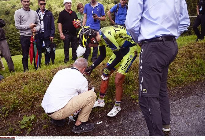 Medics check out an injured Alberto Contador