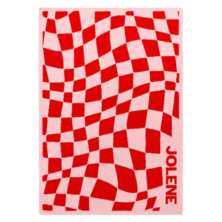 A pink and red checkered throw blanket customized with the name "Jolene"