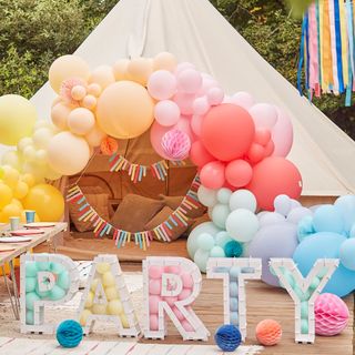 Teepee tent with colourful balloon arch and flags plus PARTY stand