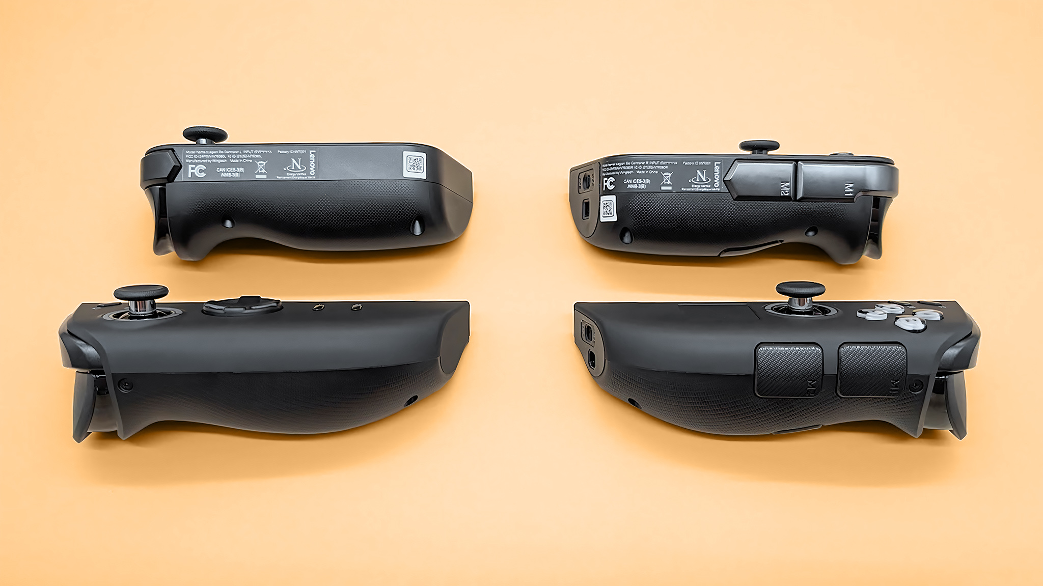 The Lenovo Legion Go 2 and original Legion Go controllers lying on their sides so the outer buttons are visible.