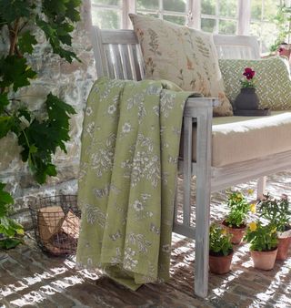 bench with pretty floral throws and cushions in a traditional style