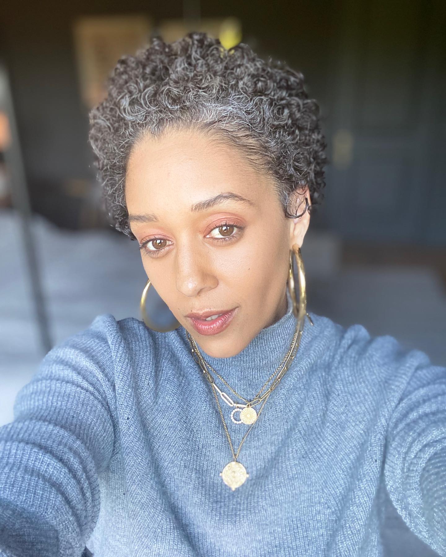 Tia Mowry with a short, salt and pepper tapered cut