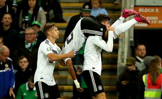 Serge Gnabry, upside down, is picked up in celebration after scoring Germany's second