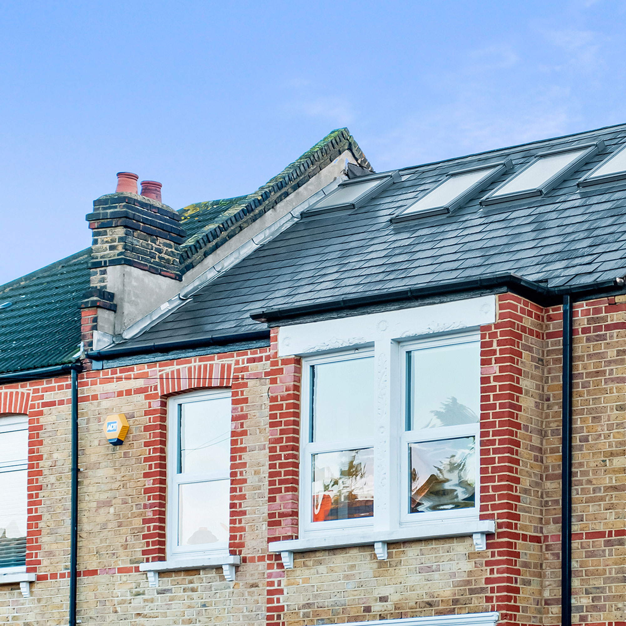 London stock brick terraced house with slate roof and skylights