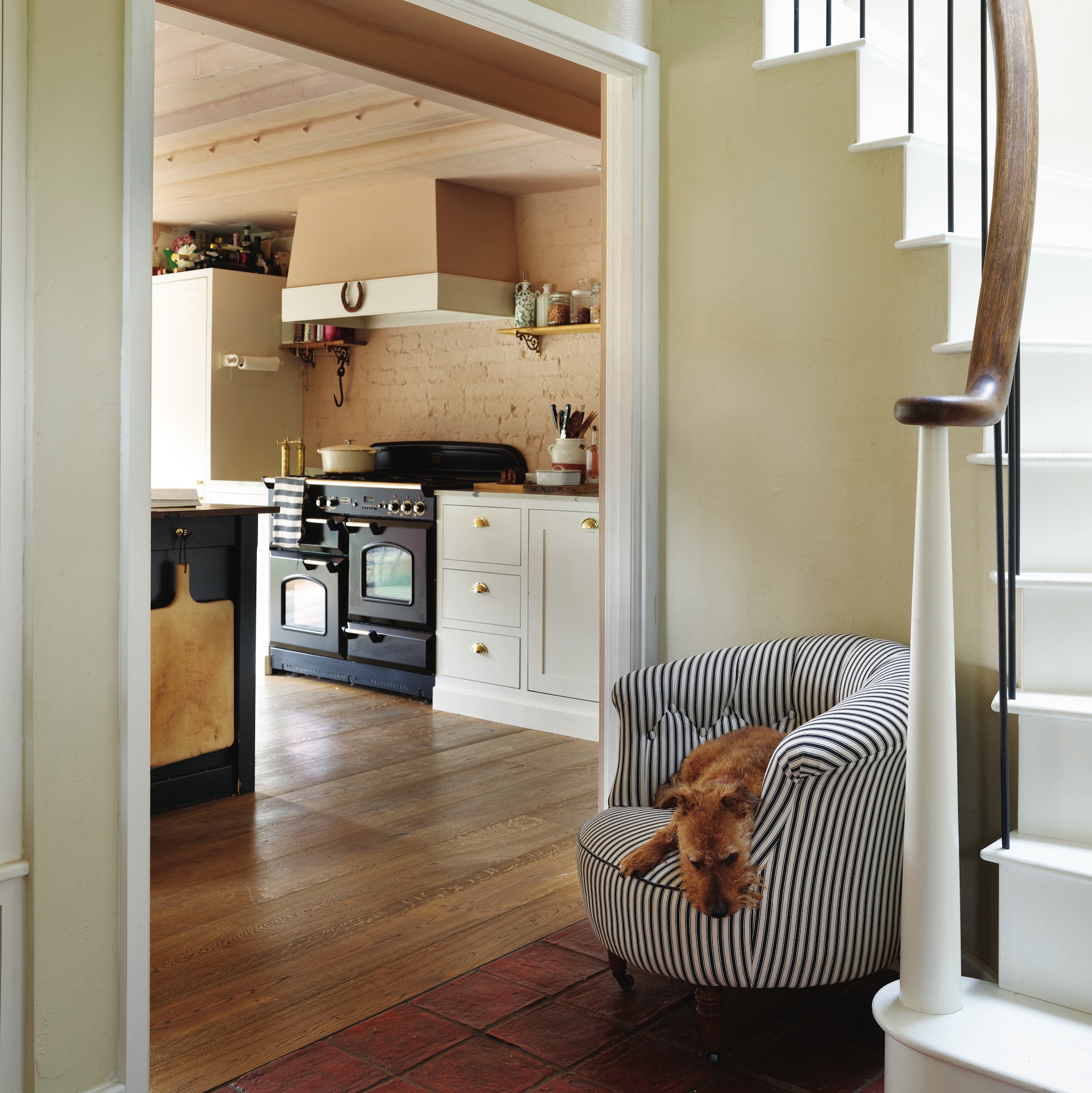 cottage kitchen with farmhouse table and bench covered with navy blue sheepskin