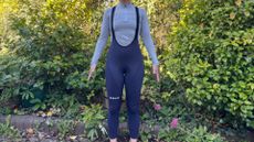 Universal Colours Mono Tights on navy blue on a white woman in a gray baselayer standing in front of greenary