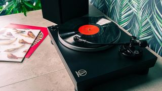 Audio-Technica LP5X turntable on a table playing a record
