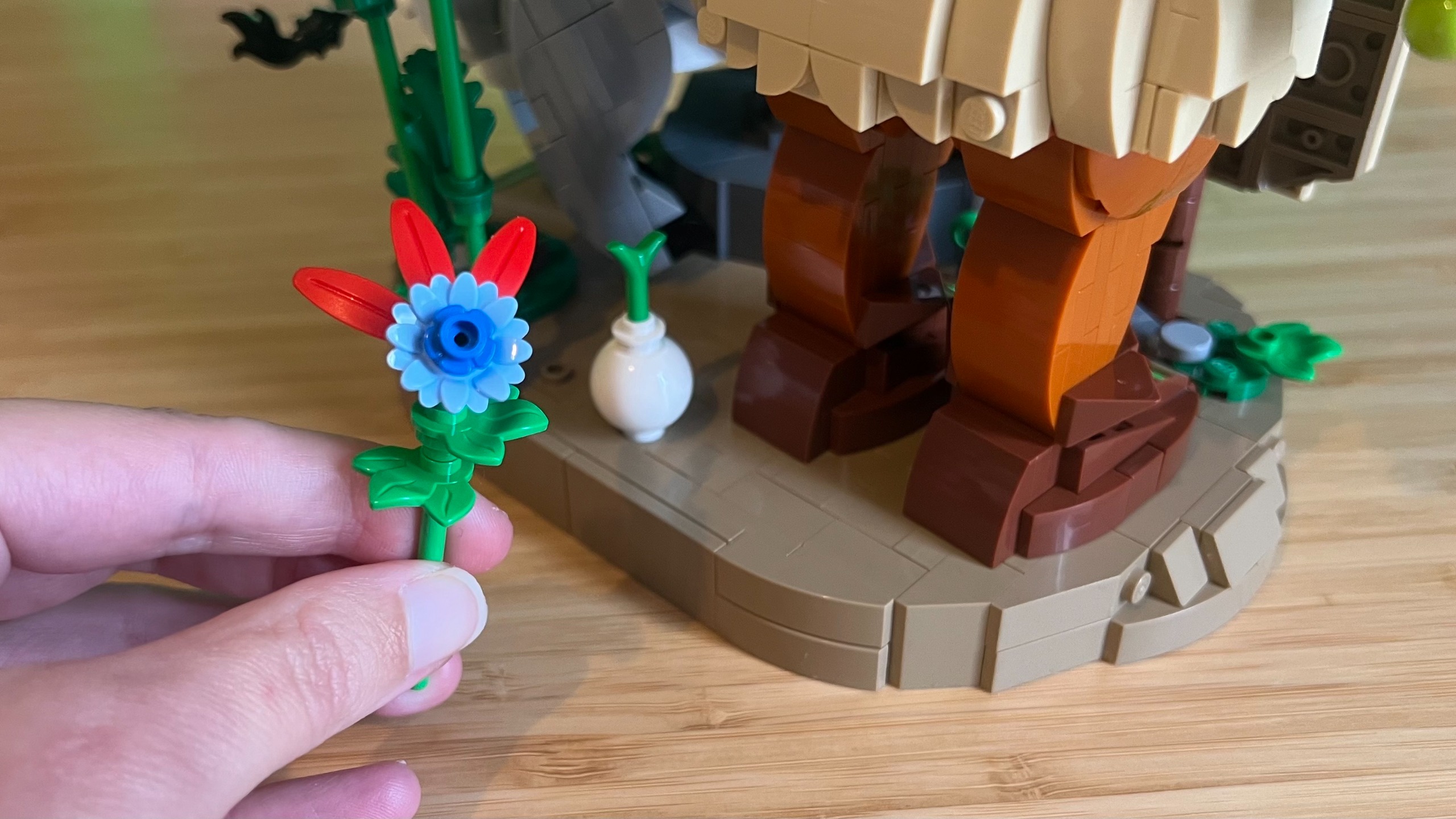 A blue Lego flower with red thorns behind the Lego Shrek, Donkey &amp; Puss in Boots set