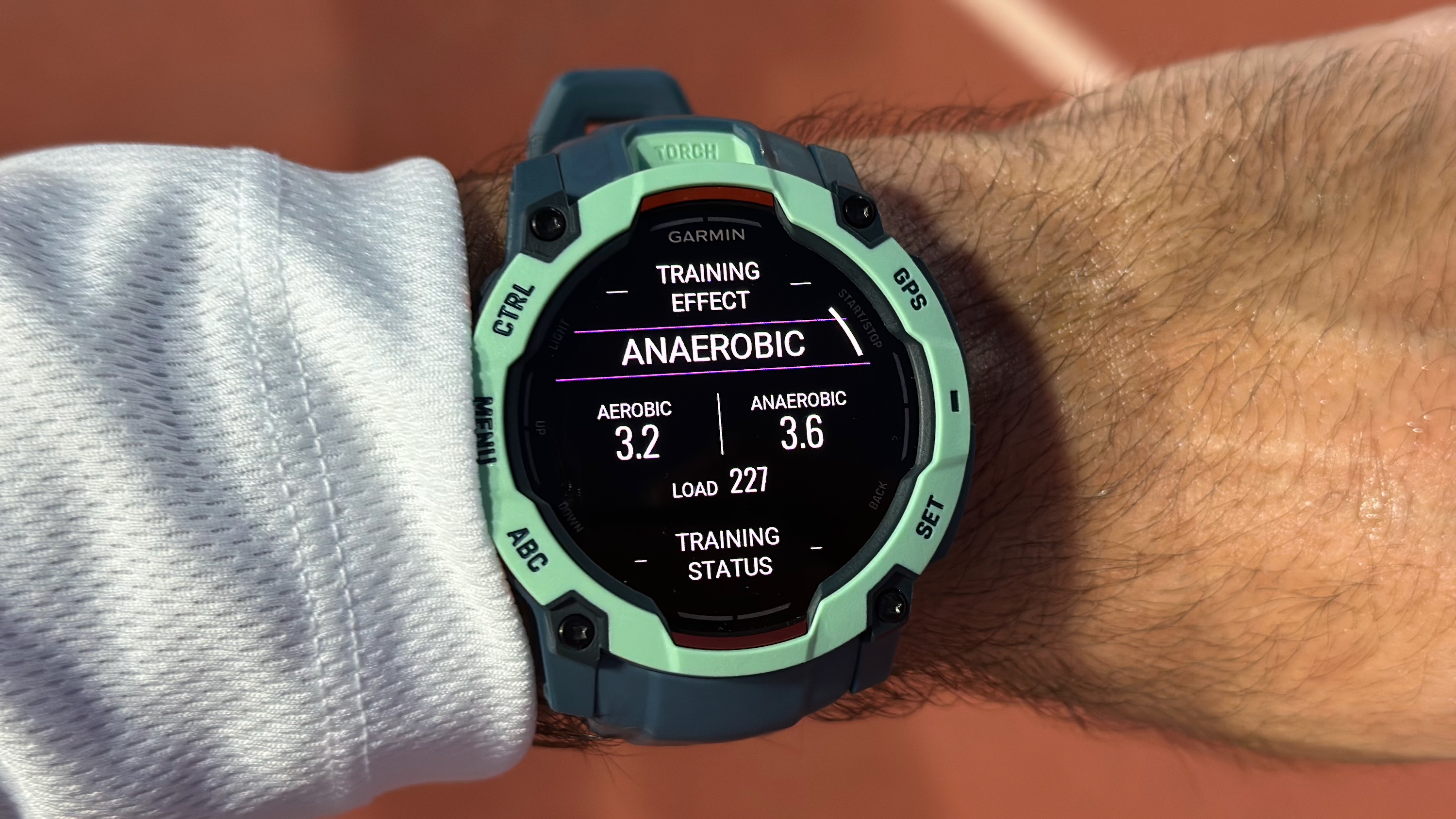A post-run Training Effect widget on the Garmin Instinct 3, showing aerobic and anaerobic training effect and total training load.