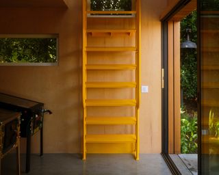 yellow staircase going up to the mezzanine at the Monon Guesthouse by Jerome Byron