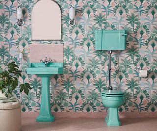 coloured sanitaryware in wallpapered bathroom