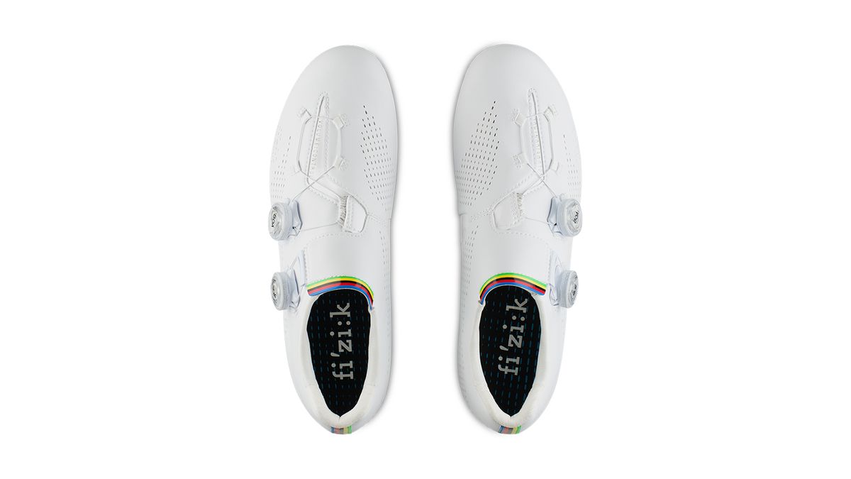 The all-white design of the shoes highlights the rainbow accents