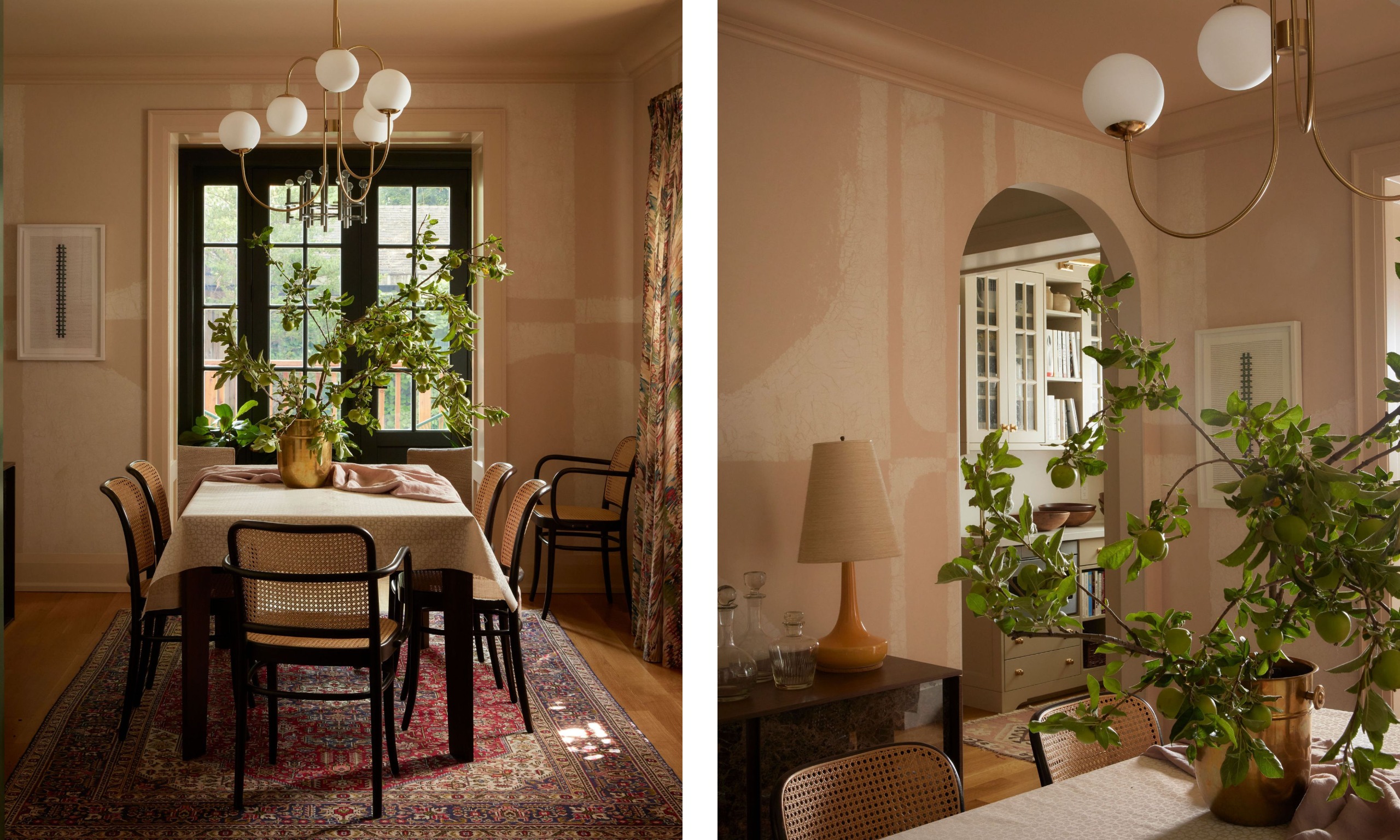 Two images of a dining room with plaster pink graphic wallpaper, a modern brass and white ceiling light, a dining table with rattan chairs, a vintage rug, and French doors leading outside.