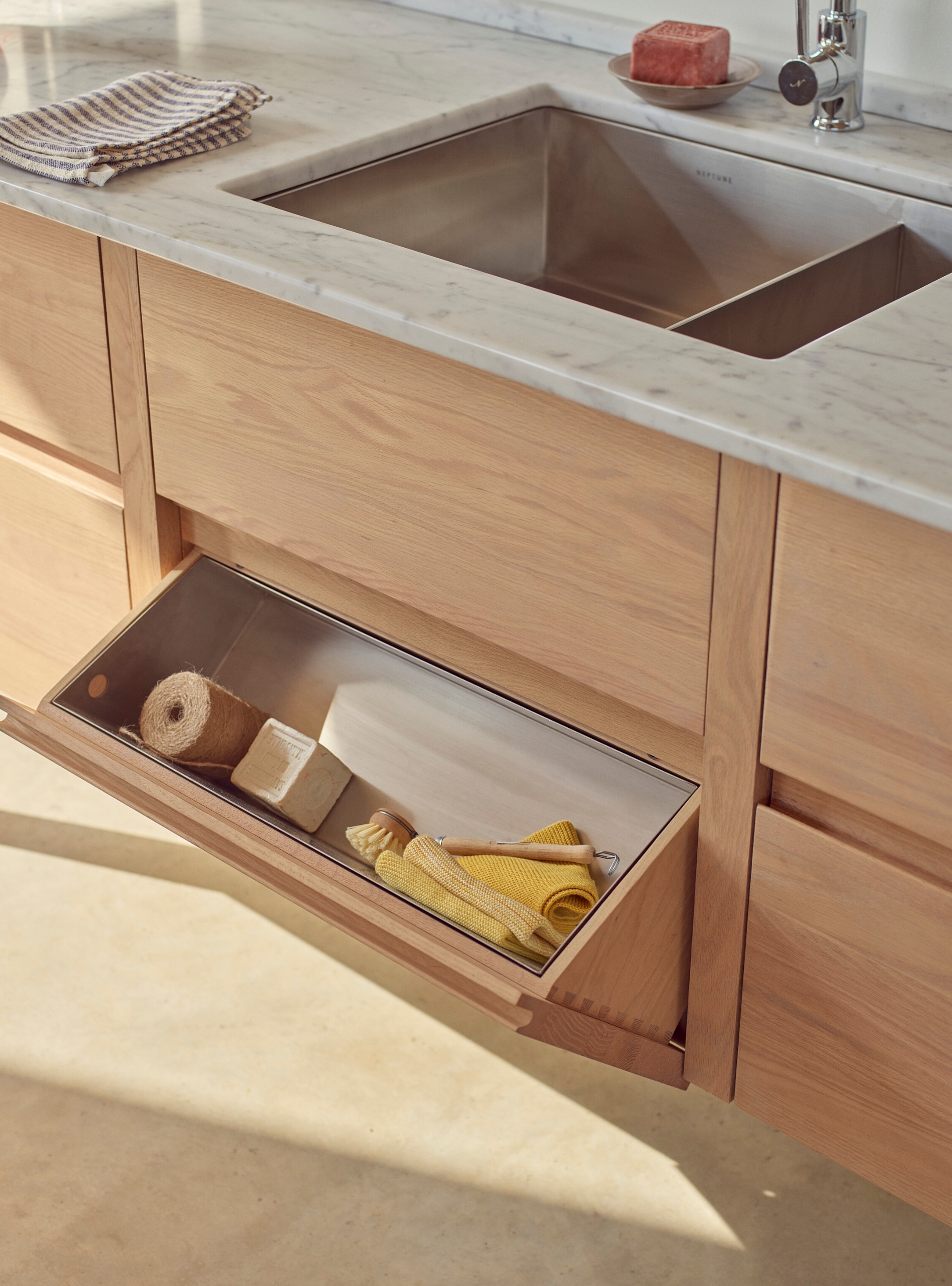 hidden storage in the false-front sink drawer by Neptune