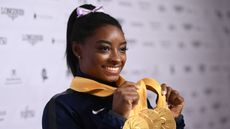Simone Biles of USA poses with her Medal haul after the Apparatus Finals on Day 10 of the FIG Artistic Gymnastics World Championships at Hanns Martin Schleyer Hall on October 13, 2019 in Stuttgart, Germany.