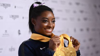 Simone Biles of USA poses with her Medal haul after the Apparatus Finals on Day 10 of the FIG Artistic Gymnastics World Championships at Hanns Martin Schleyer Hall on October 13, 2019 in Stuttgart, Germany.