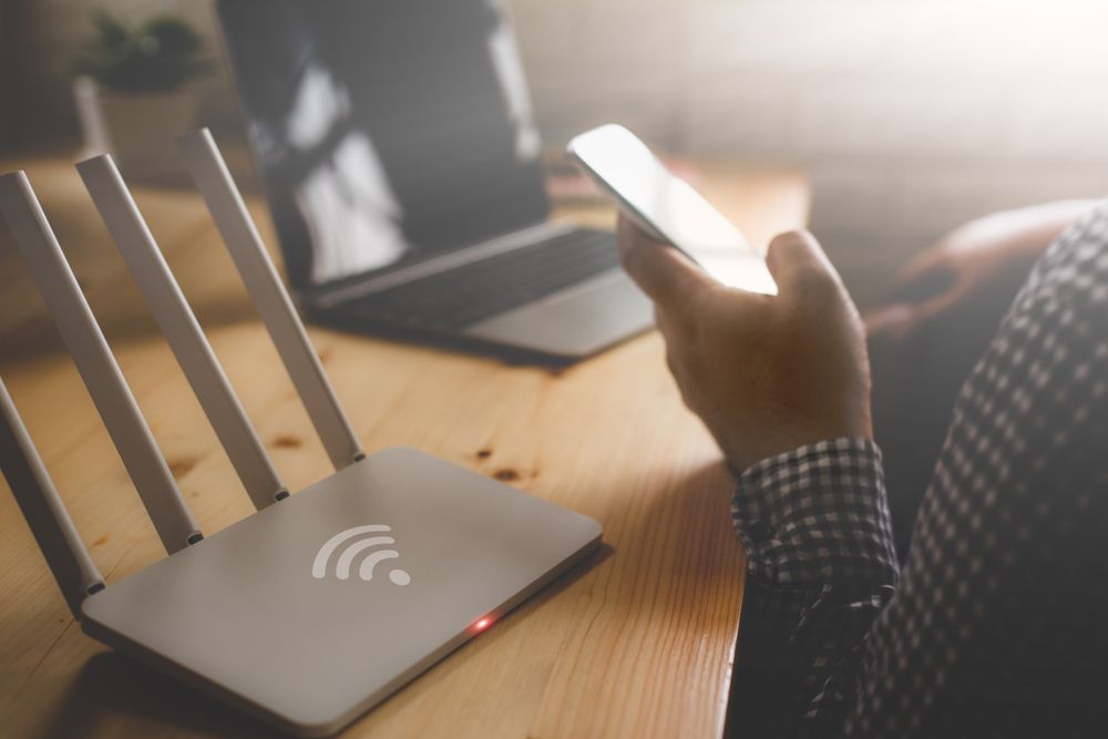 Wi-Fi router with a person holding a cellphone