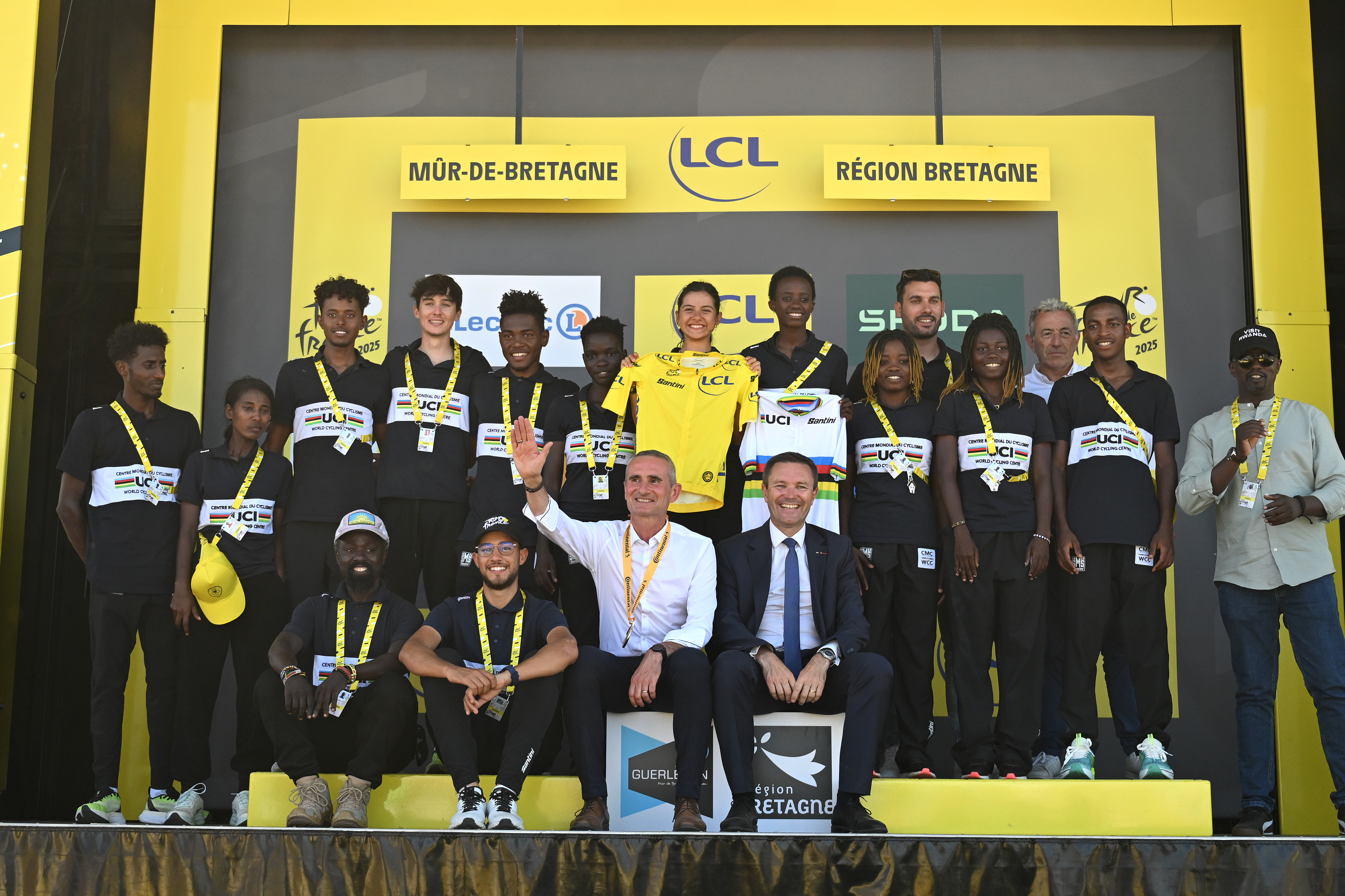 MUR-DE-BRETAGNE - GUERLEDAN, FRANCE - JULY 11: African Riders delegation from the Rwanda 2025 World Championships committee pose on the final podium alongside David Lappartient (C), President of the UCI and President of the Rwanda Cycling Federation, Samson Ndayishimiye (L) after the 112th Tour de France, Stage 7 a 197km stage from Saint-Malo to Mur-de-Bretagne (Guerledan) / #UCIWT / on July 11, 2025 in Saint-Malo, France. (Photo by Tim de Waele/Getty Images)