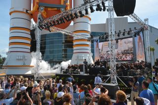 Smoke billows from the replica solid rocket boosters outside the new "Space Shuttle Atlantis" exhibit, marking the "launch" of the Kennedy Space Center Visitor Complex attraction in Florida, June 29, 2013.