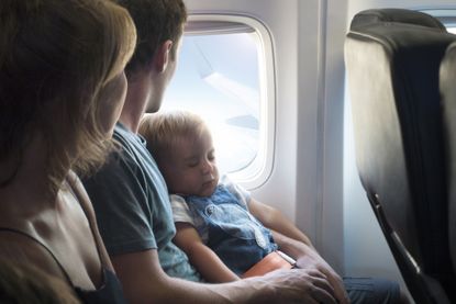 Mother, father and baby on airplane