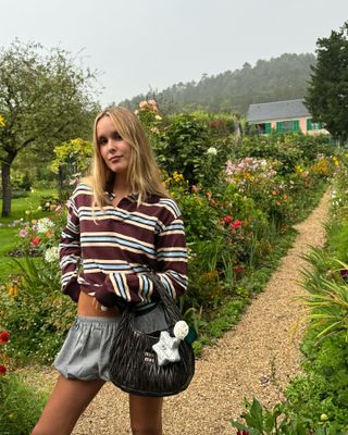 Woman in striped polo top and bubble skirt.